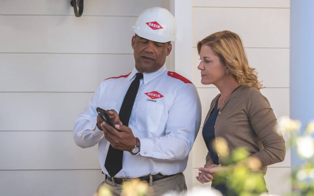 Orkin Technician showing recommendations to client
